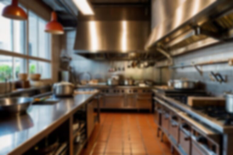 Interior of restaurant kitchen with professional utensils, out of focus, blurred